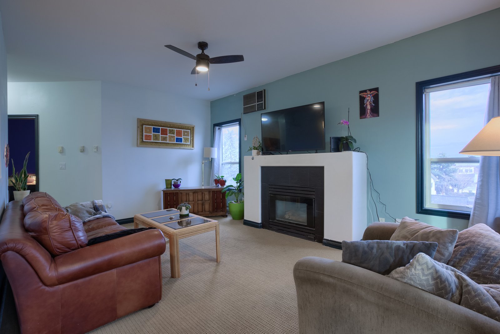 Bright living room with lake views and gas fireplace